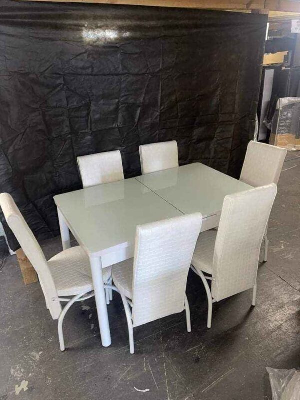 white dining table set with six chairs