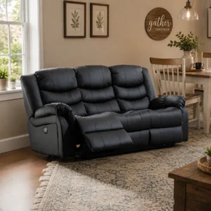 A contemporary black leather 3-seater power recliner sofa displayed in a cozy, warmly lit home interior with a patterned area rug, wooden flooring, framed botanical wall art, and a dining area in the background.