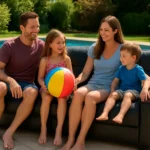 3 seater sofa bed balck leather along side pool siting famiy on it couple and one girl chil with ball and one boy child