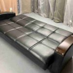 leather black sofa bed in sleeping look