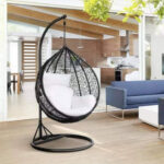 Black hanging egg chair with stand with white cushions