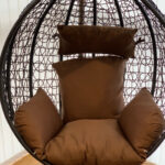 Brown hanging chair with stand, cushions pic