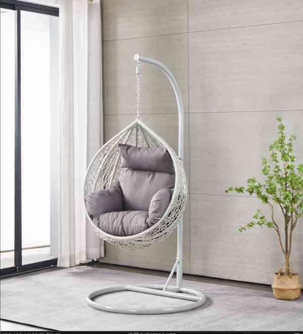 Single white egg chair with stand and cushions